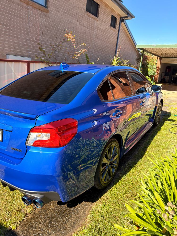 Glossy blue Subaru WRX paintwork reflecting the light