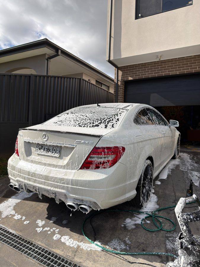 Mini detail: a white Mercedes coupe covered in snow foam