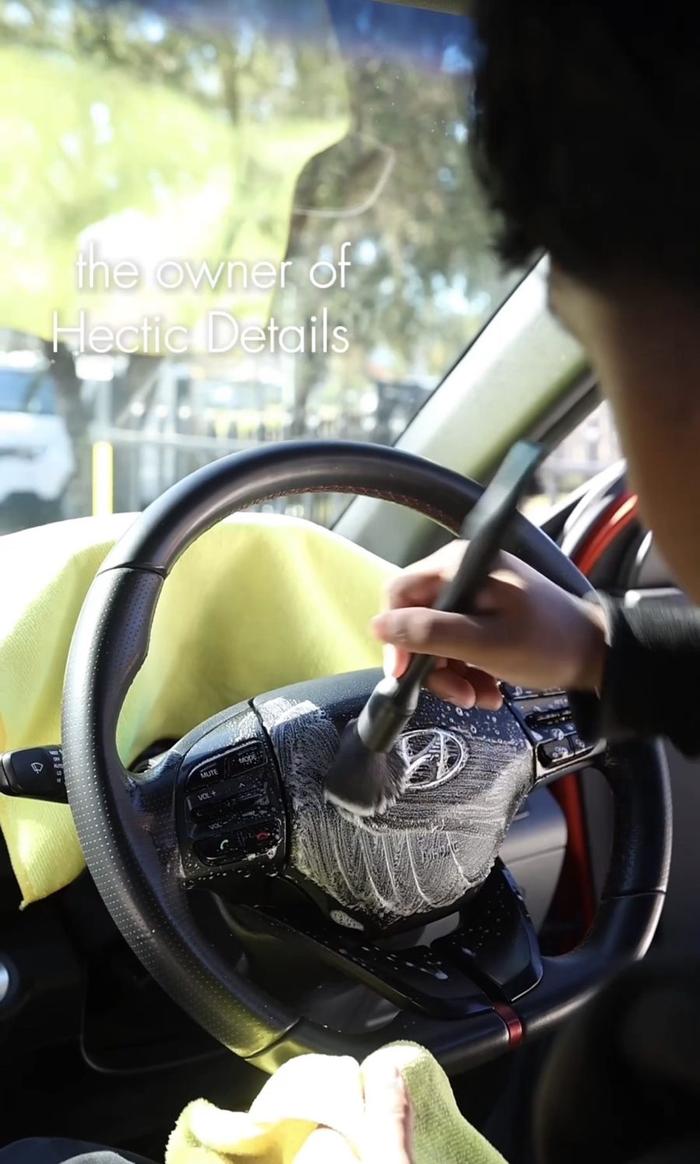 Manav, owner of Hectic Details, detailing a steering wheel